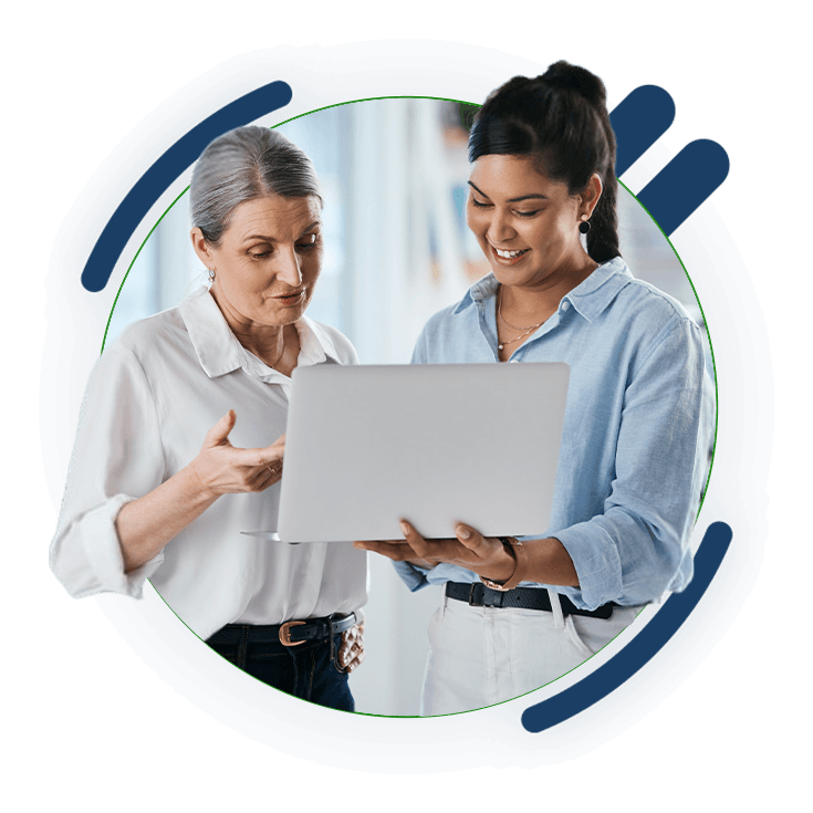 Two women reviewing information on a laptop